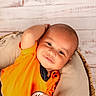 William joined the competition — help win amazing prizes! baby, child, infant, smile, orange_clothing, basket, cushion, relaxed, portrait, indoors, cute, face, head, skin, happy, resting, toddler, comfort, young, person