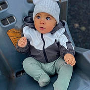 Raheem is registered to the contest to win money with this photo: baby, child, cozy, curious, cute, cute_baby, expression, eyes, face, hat, infant, jacket, outdoor, pom_poms, portrait, seat, sitting, small_hand, warm_clothes, winter_clothing