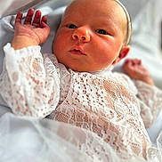 Kaelyn is registered to the contest to win money with this photo: baby, infant, lace, white, clothing, headband, face, hand, newborn, portrait, cute, soft, fabric, delicate, closeup, skin, person, child, babywearing, resting