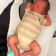 Ryland joined the competition — help win amazing prizes! newborn, baby, sleeping, infant, striped_onesie, sock, soft_surface, peaceful, cute, small, child, resting, indoors, padded_bed, relaxed, skin, head, legs, arms, portrait