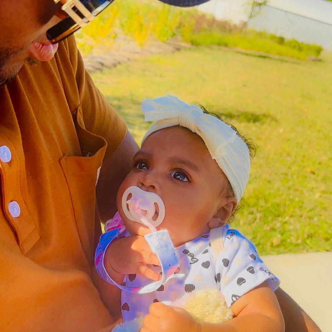 Kamia joined the competition — help win amazing prizes! adult, affection, arm, baby, blanket, cap, child, clothing, garden, grass, headband, holding, love, man, outdoor, pacifier, portrait, skin, sunglasses, sunlight