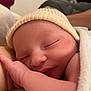 newborn, baby, sleeping, infant, hat, knit_cap, blanket, close_up, peaceful, cute, skin, hand, face, resting, cozy, indoors, soft_light, child, portrait, toddler