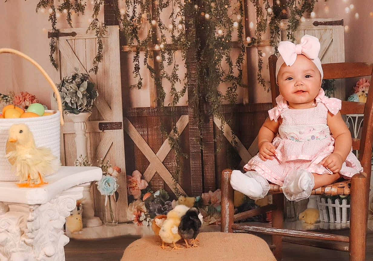 Azaria joined the competition — help win amazing prizes! chair, child, companion_dog, doll, dress, event, fashion_design, fawn, fur, headwear, ornament, peach, person, pink, plant, room, sitting, textile, toy, tree