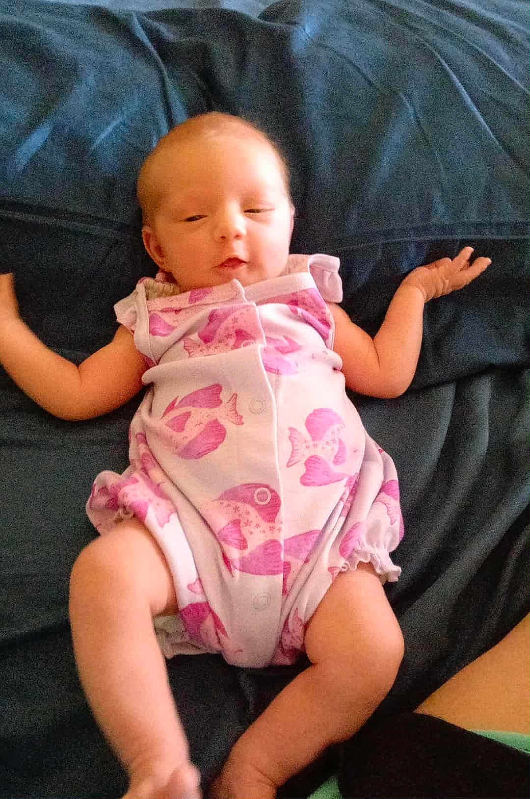 Aaliyahrose joined the competition — help win amazing prizes! baby, infant, onesie, pink, fish_pattern, blanket, lying_down, arms_outstretched, sleepy, content, skin, child, cute, newborn, soft, casual, home, relaxed, comfort, infancy