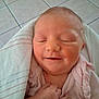 Aaliyahrose is registered to the contest to win money with this photo: newborn, baby, infant, sleeping, smiling, blanket, hand, face, skin, clothing, person, portrait, indoors, floor, tile, cute, peaceful, closeup, resting, soft