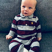 Lenny joined the competition — help win amazing prizes! baby, child, striped_clothing, cast, foot_cast, couch, gray_couch, sitting, curious_expression, indoor, portrait, infant, casual_wear, long_sleeves, pants, knitted_fabric, young_child, one_person, seated, cozy