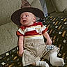 Theodore is registered to the contest to win money with this photo: baby, infant, wizard_hat, harry_potter, blanket, clothing, socks, couch, home_interior, portrait, child, cute, costume, relaxing, furniture, cozy, casual, indoor, young, person