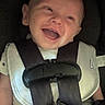 baby, car_seat, child, smile, harness, safety, happy, infant, seat_belt, white_clothing, black_straps, child_safety, cute, portrait, young, person, baby_smiling, seat, closeup, child_protection