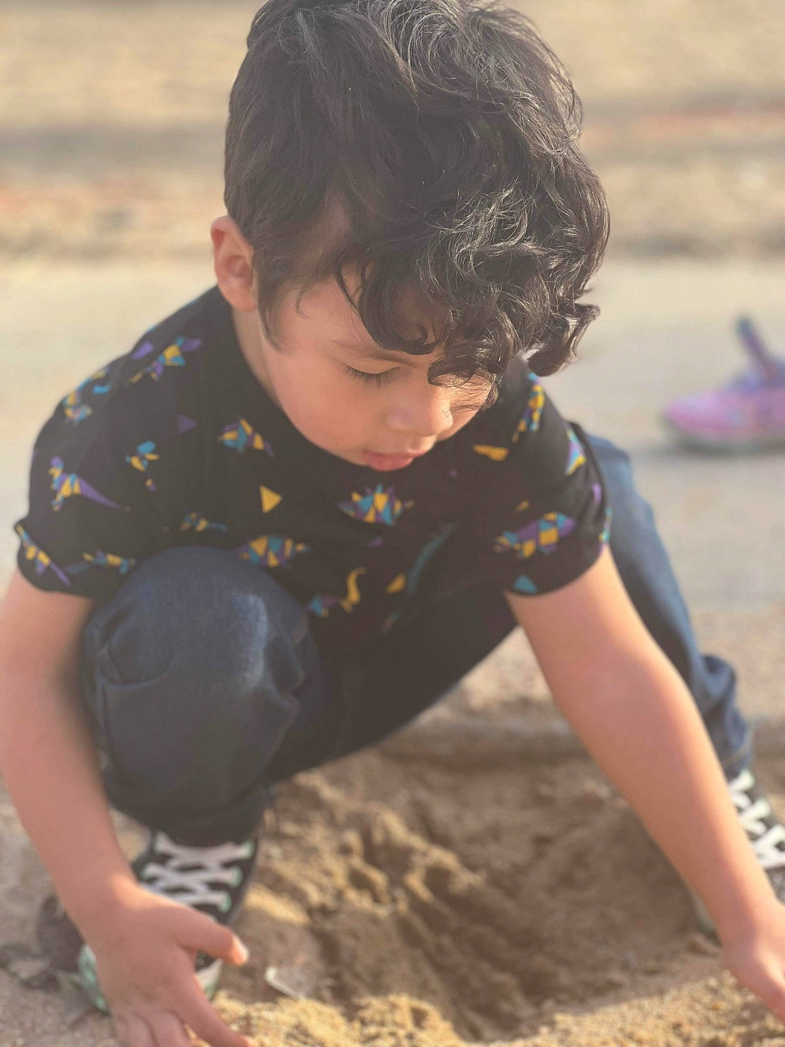 Joshua is registered to the contest to win money with this photo: beach, child, coast, fun, hairstyle, happy, human, landscape, leisure, ocean, people_in_nature, people_on_beach, person, play, recreation, sitting, soil, t_shirt, thigh, toddler