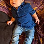 Myles joined the competition — help win amazing prizes! toddler, child, baby, blue_shirt, denim_jeans, socks, blanket, moon_pattern, star_pattern, indoor, cute, casual_clothing, portrait, laying_down, curious_expression, young_child, fabric, clothing, person, soft_lighting