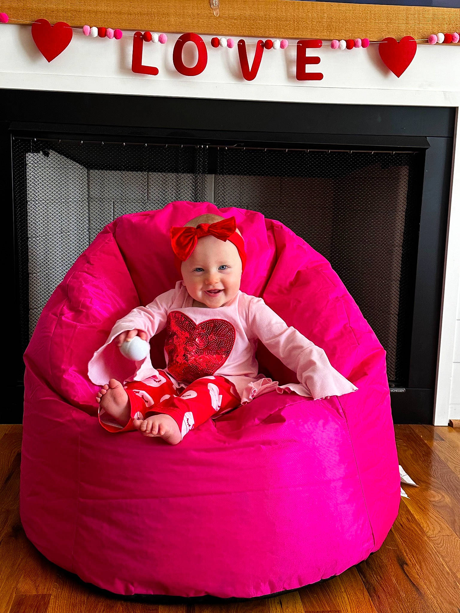 Adalyn is registered to the contest to win money with this photo: baby, baby_products, baby_toddler_clothing, bean_bag, child, comfort, flooring, fun, happy, hardwood, headwear, joy, magenta, person, pink, play, purple, rectangle, room, sitting