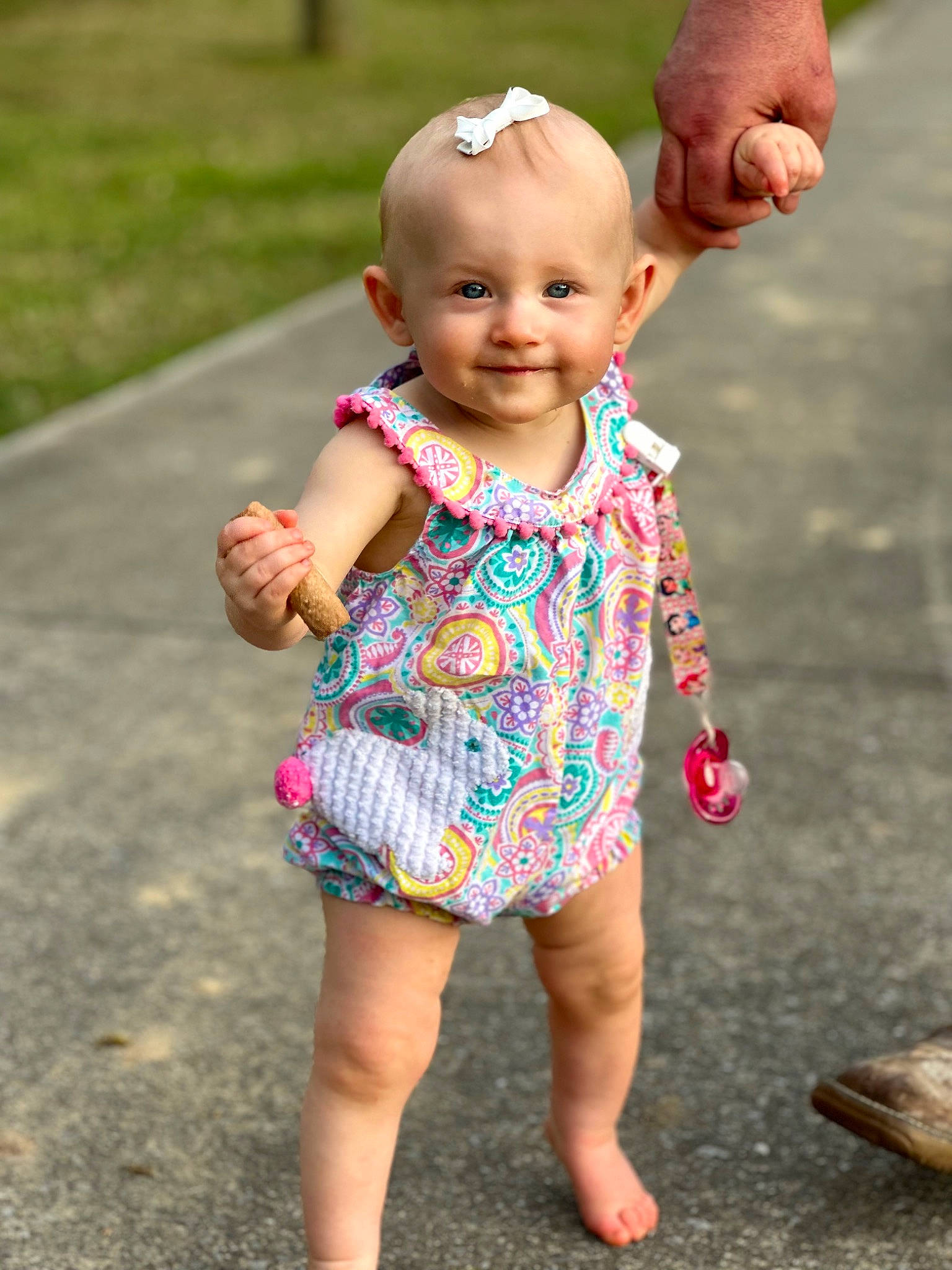 Adalyn is registered to the contest to win money with this photo: baby, baby_toddler_clothing, child, finger, gesture, grass, hand, happy, head, joy, leg, leisure, people_in_nature, person, pink, plant, skin, sleeve, smile, summer