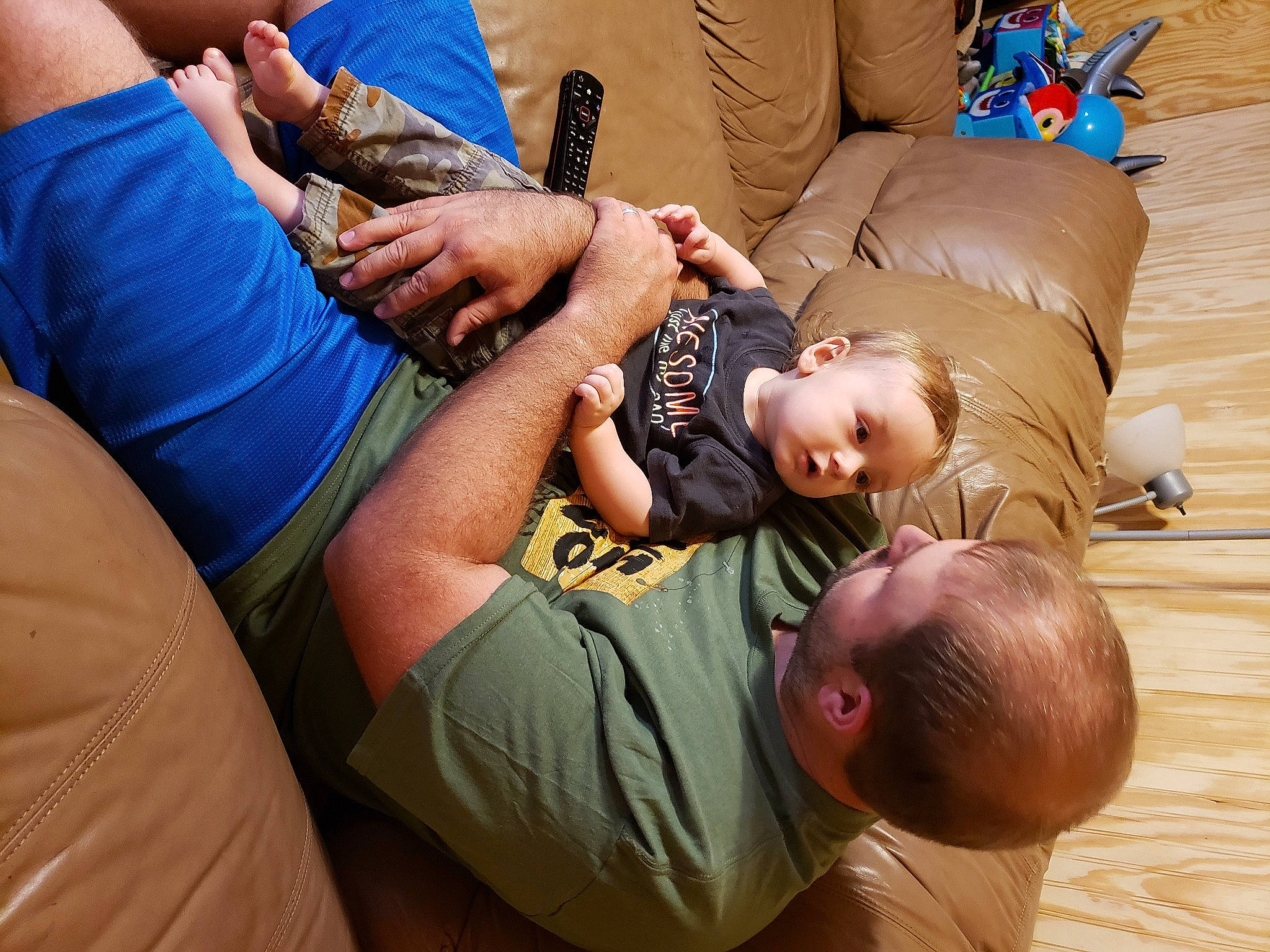 Edward is registered to the contest to win money with this photo: arm, clothing, comfort, elbow, finger, gesture, hand, happy, joint, knee, leg, leisure, mammal, muscle, person, shoulder, t_shirt, thigh, toddler, wood