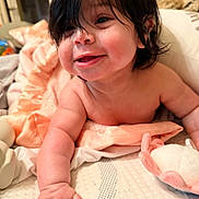 Lina Rose joined the competition — help win amazing prizes! baby, child, smiling, indoor, blanket, soft_toy, mattress, person, cute, skin, hand, face, hair, infant, lying_down, cozy, expression, closeup, happy, toddler