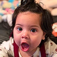 Lina Rose is registered to the contest to win money with this photo: baby, baby_girl, black_hair, child, closeup, clothing, cute, expression, eyes, face, floral_pattern, hair, indoors, infant, mouth_open, person, portrait, skin, surprise, young