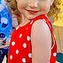 Lucy joined the competition — help win amazing prizes! child, toddler, girl, red_dress, polka_dots, white_bow, curly_hair, blonde_hair, smile, rosy_cheeks, close_up, portrait, candid, indoor, festive, looking_down, fair_skin, sleeveless, arm, colorful_background