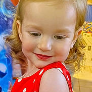 Lucy joined the competition — help win amazing prizes! child, toddler, girl, portrait, close_up, red_dress, polka_dots, red_bow, curls, smile, cheeks, eyelashes, blonde_hair, indoor, playful, shoulder, cute, fashion, face, happy