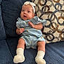 Amaryllis Perez is registered to the contest to win money with this photo: baby, blue_couch, bow, child, comfort, curious, cute, denim_outfit, headband, home, indoors, infant, patterned_cushion, portrait, relaxed, sitting, small_hands, soft_fabric, white_socks, young