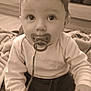baby, pacifier, toy, blanket, child, indoor, play, curious, sepia, closeup, face, hands, clothing, floor, infant, expression, person, candid, young, cute