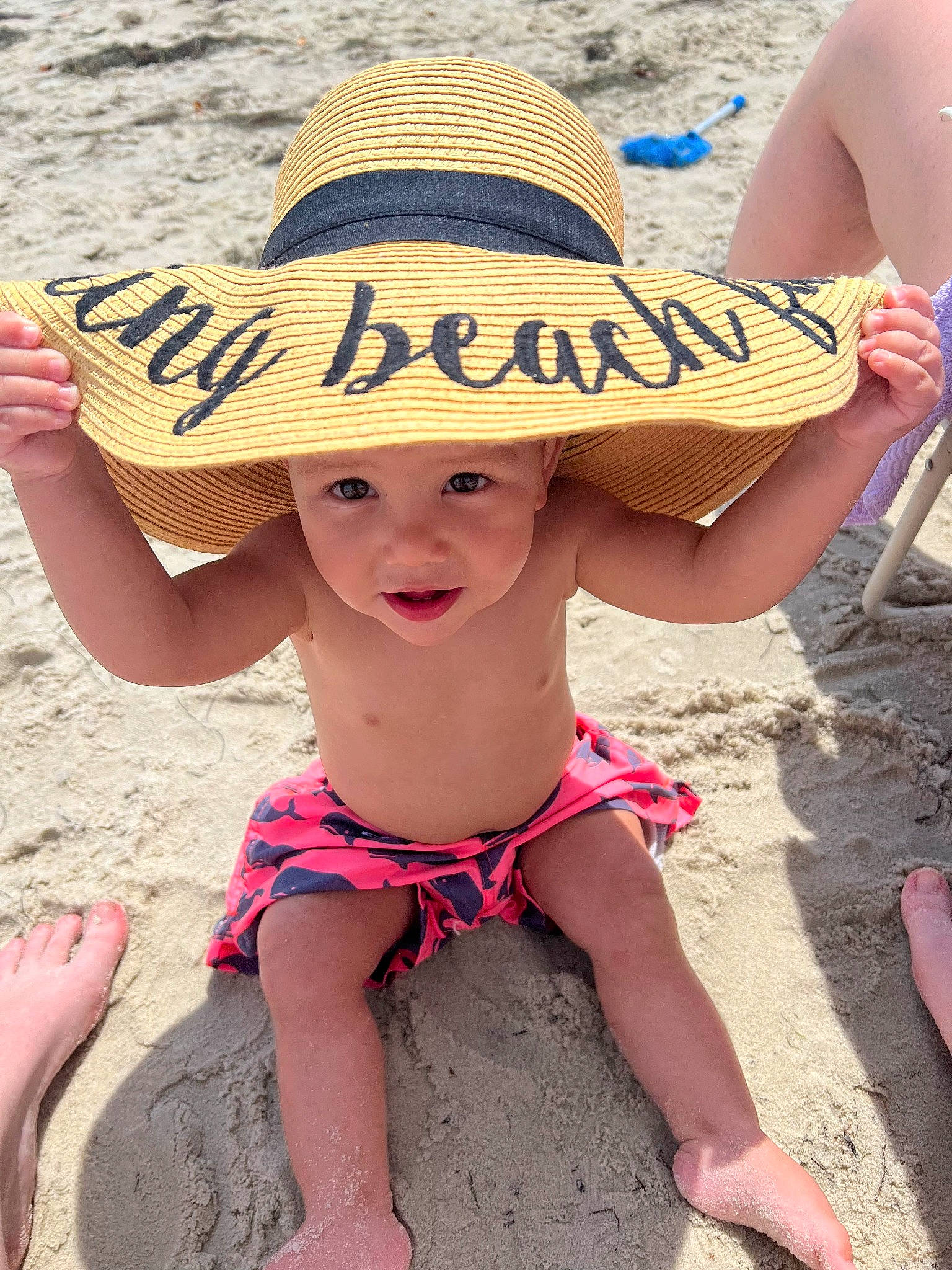 Zacheriah is registered to the contest to win money with this photo: beach, body_of_water, brassiere, fun, hairstyle, happy, hat, headgear, headwear, human_leg, leisure, light, people_in_nature, people_on_beach, person, photograph, sand, summer, sun_hat, swimwear