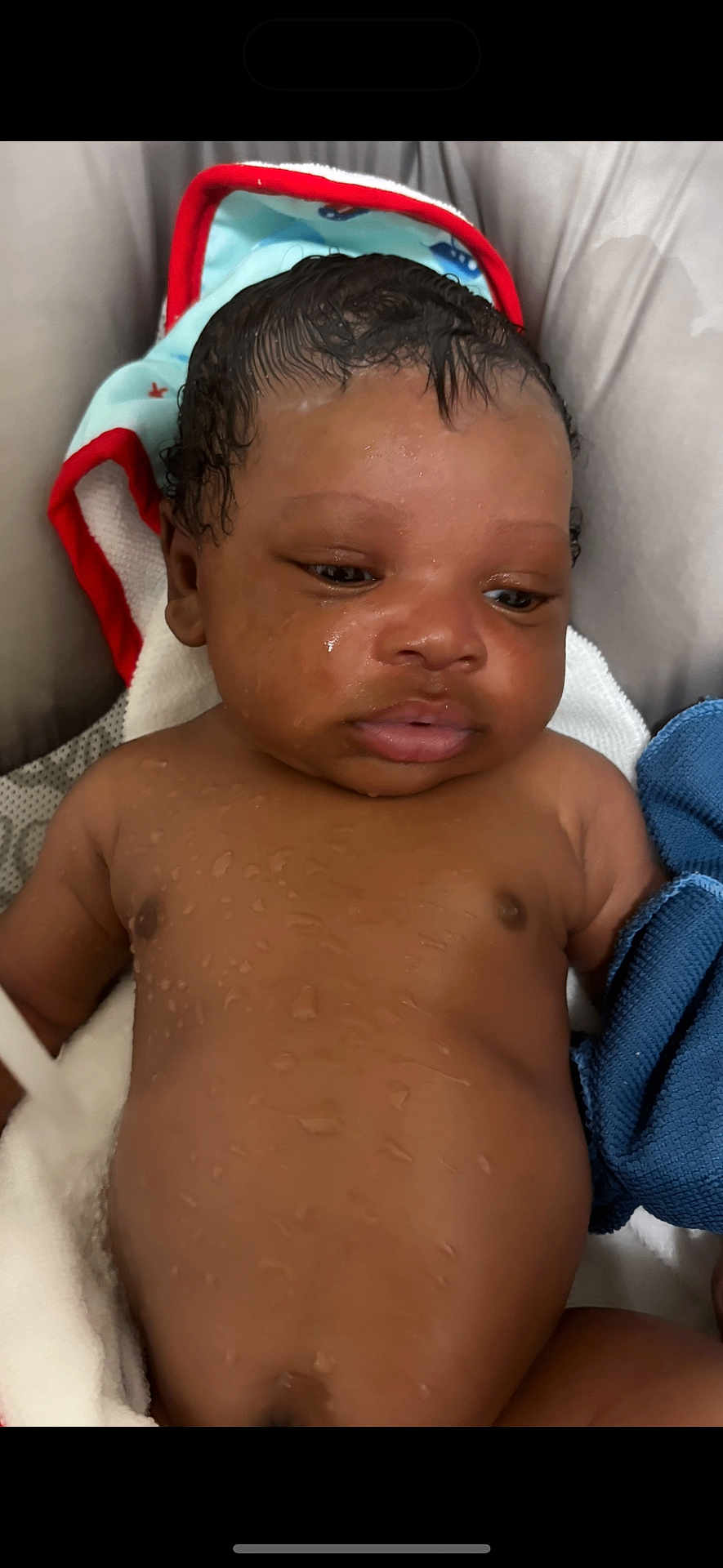 Dakari is registered to the contest to win money with this photo: baby, wet_skin, towel, infant, face, portrait, child, water_droplets, hooded_towel, skin, newborn, sleepy, closeup, cute, indoors, person, soft, young_child, expression, resting