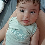 Thiago Garcias joined the competition — help win amazing prizes! baby, infant, child, face, eyes, tongue, onesie, clothing, diaper, lap, person, skin, hair, blanket, bed, comfort, cute, expression, indoors, portrait