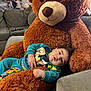 baby, child, teddy_bear, plush, sofa, couch, furniture, indoor, cute, smiling, person, clothing, mickey_mouse, cartoon, relaxing, home, comfort, portrait, toy, soft