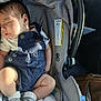 baby, sleeping, car_seat, overalls, clothing, blanket, socks, nike, infant, child, cute, peaceful, indoor, person, seat, head, face, legs, soft_light, resting