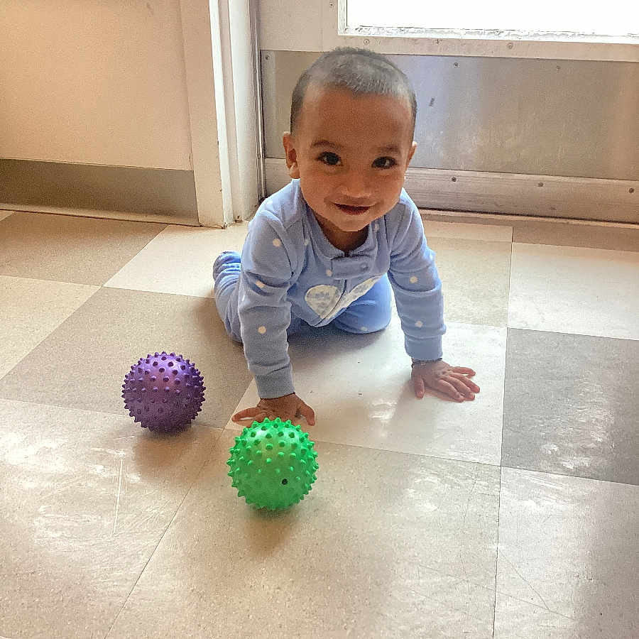 Viraaj joined the competition — help win amazing prizes! baby, background, balls, blue_clothing, child, crawling, daylight, feet, floor, hands, happy, head, indoor, person, play, polka_dots, smiling, toy, window, young_child