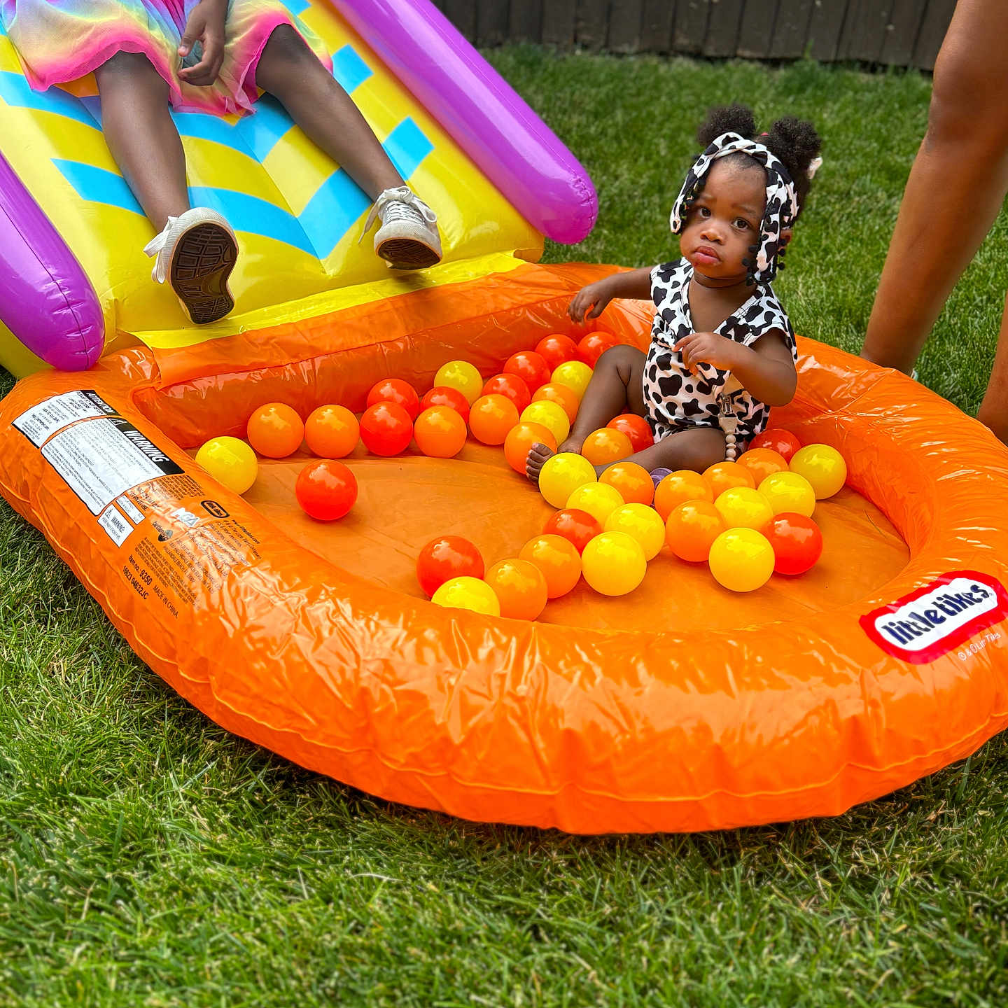 Kennedi is registered to the contest to win money with this photo: boy, child, clothing, face, female, footwear, girl, grass, head, inflatable, male, outdoors, person, photography, plant, playarea, portrait, shoe, slide, summer
