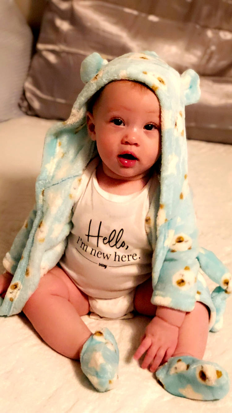 Rhami is registered to the contest to win money with this photo: arm, baby, baby_toddler_clothing, cheek, child, comfort, dress, eye, face, hand, happy, head, headwear, iris, person, pink, product, skin, sleeve, textile