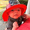 Devon Jr joined the competition — help win amazing prizes! baby, child, fireman_hat, red_hat, junior_firefighter, tattooed_arm, outdoor, person, curious, infant, holding, red_shirt, face, closeup, background_blur, fire_truck, greenery, daylight, portrait, cute