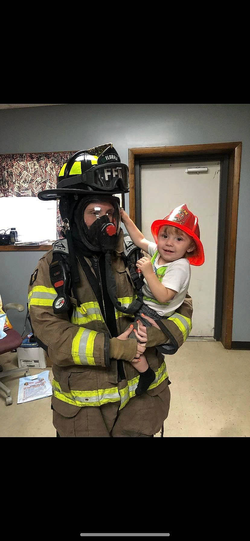 Colten is registered to the contest to win money with this photo: door, emergency, emergency_service, event, fire_department, firefighter, fun, gas, gas_mask, hard_hat, headgear, headwear, helmet, high_visibility_clothing, joy, oxygen_mask, person, personal_protective_equipment, rescue, rescuer