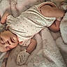 Makayla is registered to the contest to win money with this photo: baby, infant, sleeping, lying_down, portrait, face, closed_eyes, blanket, plush_toy, stuffed_animal, bed, pink_clothing, heart_pattern, onesie, mittens, cozy, indoors, soft_texture, nap, cute