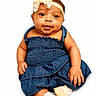 Merci is registered to the contest to win money with this photo: baby, infant, child, denim_dress, headband, bow, cute, smile, socks, white_background, portrait, sitting, chubby_cheeks, skin, face, eyes, hands, feet, clothing, fashion