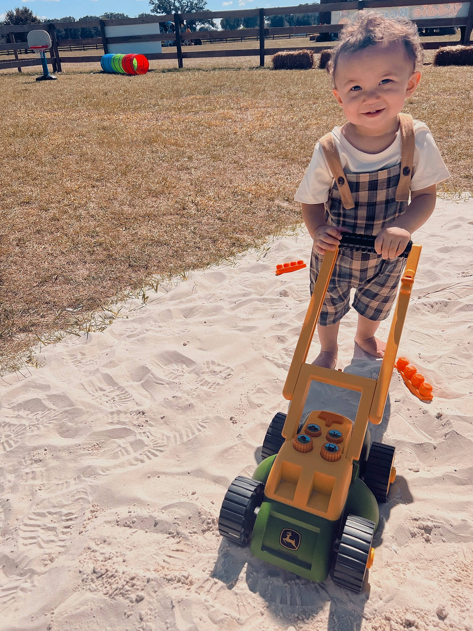 Anakin is registered to the contest to win money with this photo: asphalt, baby, baby_toddler_clothing, child, fun, grass, joy, landscape, leisure, people_in_nature, person, play, recreation, rolling, sand, sky, soil, toddler, toy, travel