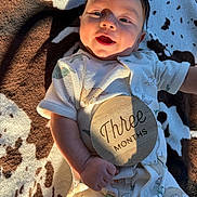 Wylder joined the competition — help win amazing prizes! baby, infant, child, smiling, portrait, lying_down, blanket, cow_pattern, milestone, three_months, plaque, onesie, clothing, sunlight, indoor, close_up, face, happy, photography, family_moment