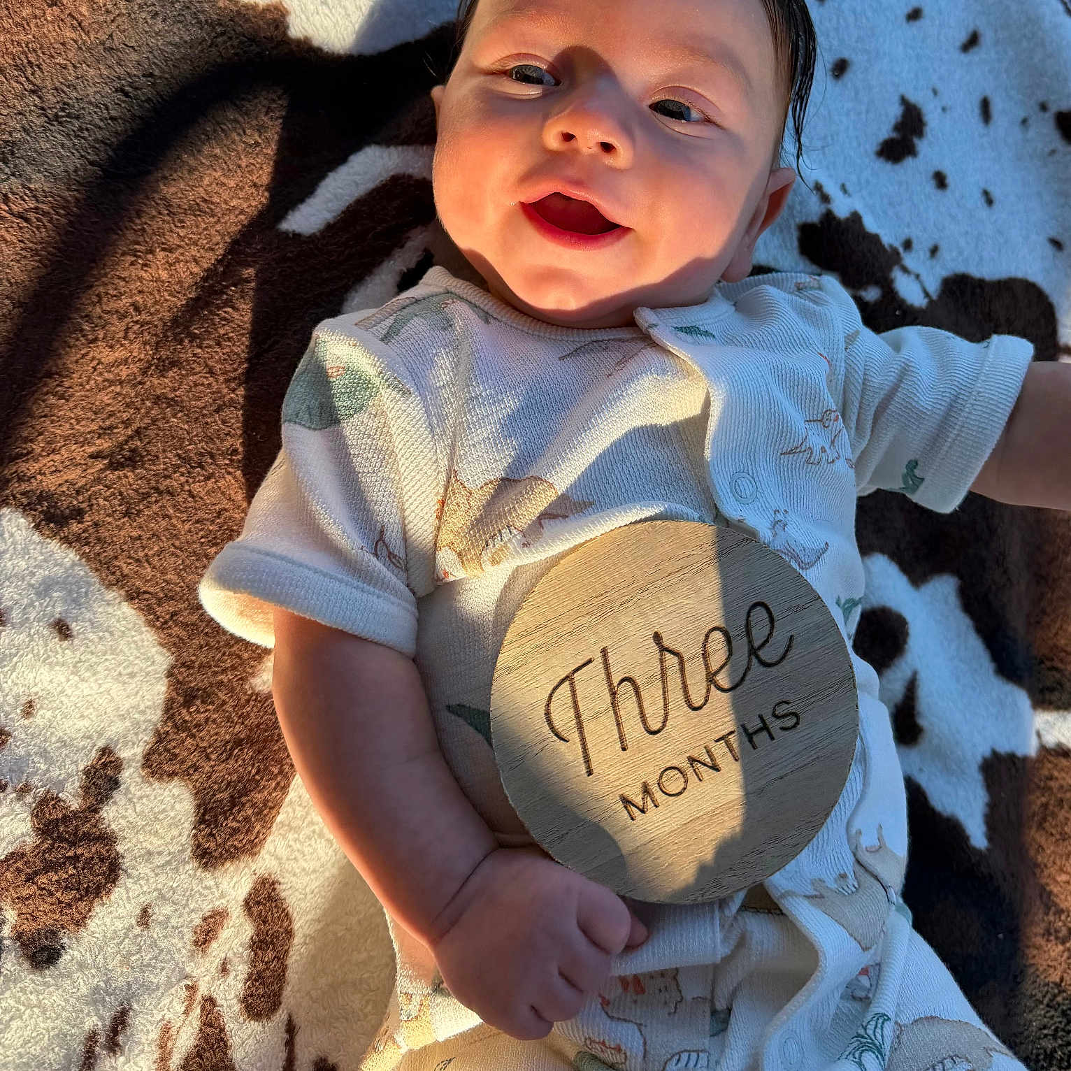 Wylder joined the competition — help win amazing prizes! baby, infant, child, smiling, portrait, lying_down, blanket, cow_pattern, milestone, three_months, plaque, onesie, clothing, sunlight, indoor, close_up, face, happy, photography, family_moment