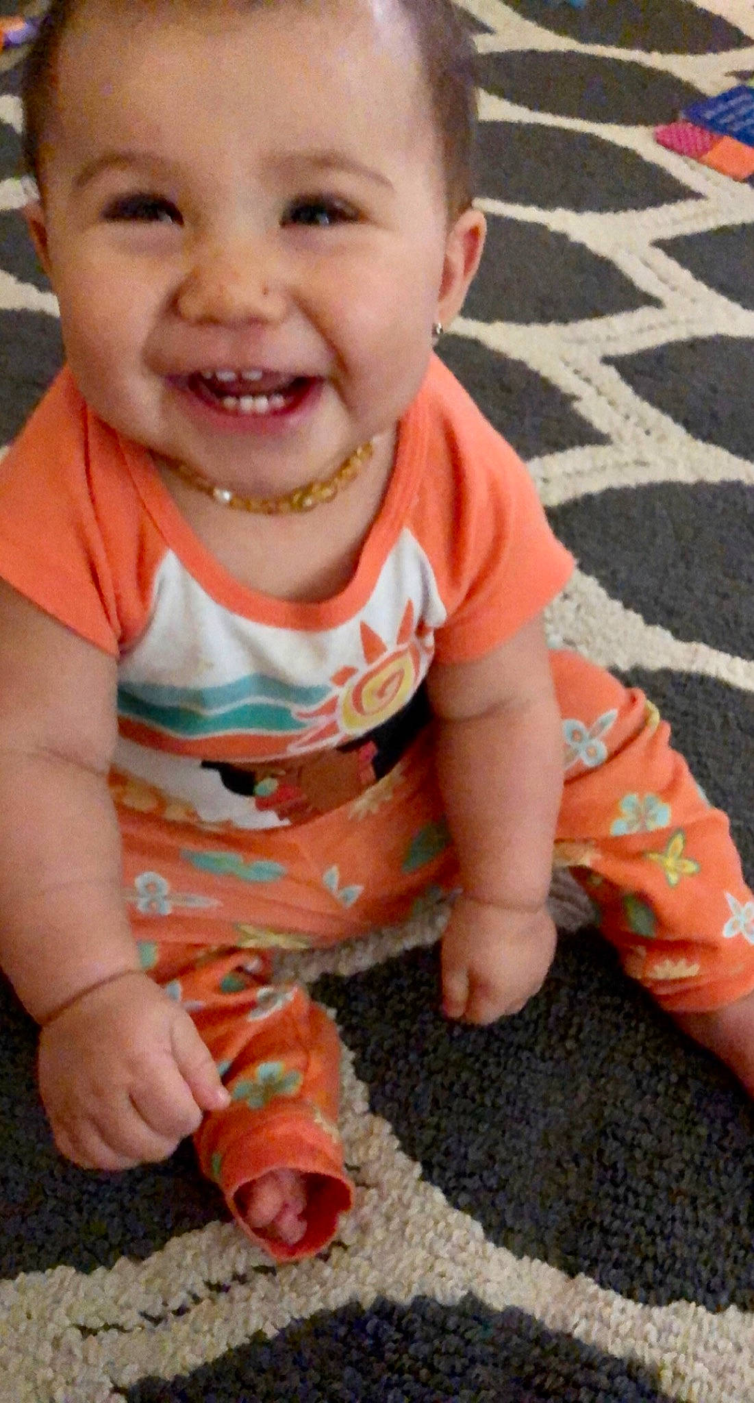 Keilani is registered to the contest to win money with this photo: baby, child, crawling, facial_expression, finger, joy, laugh, orange, person, play, smile, toddler