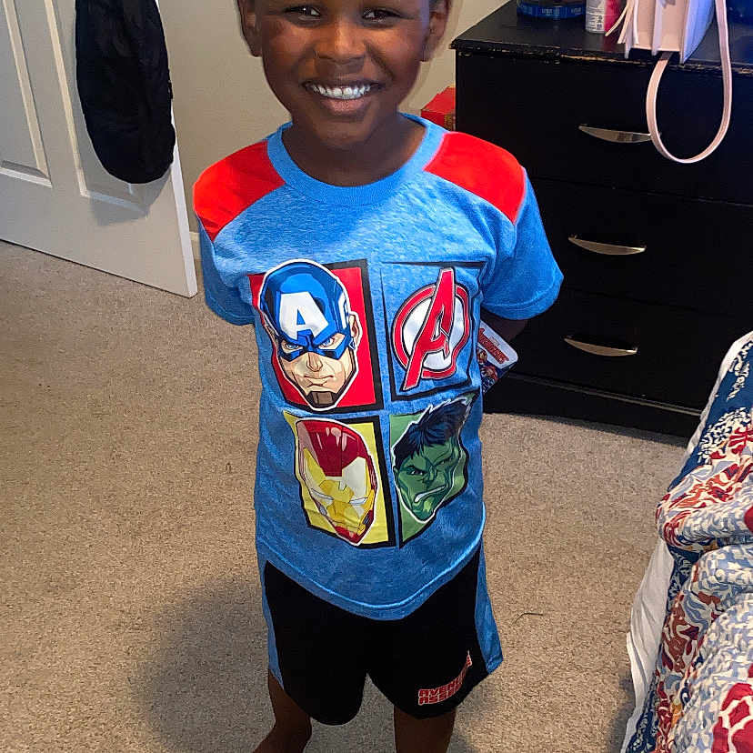 Kentrell joined the competition — help win amazing prizes! barefoot, bedroom, boy, carpet, child, clothing, door, dresser, furniture, happy, indoor, lamp, person, purse, quilt, shorts, smile, standing, toy, tshirt