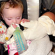 Everlyn is registered to the contest to win money with this photo: baby, blanket, bottle, child, comfort, cozy, cute, doll, face, feeding, hand, indoor, nap_time, pajamas, resting, sleepy, soft_toy, stroller, toddler, young_child