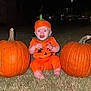 Everlyn is registered to the contest to win money with this photo: baby, barefoot, child, clothing, costume, expression, face, festive, grass, halloween, headwear, night, orange, outdoor, person, pumpkin, scary, sitting, stem, two_pumpkins
