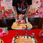 Everlyn joined the competition — help win amazing prizes! baby, birthday, cake, celebration, child, decorations, high_chair, party, person, pink, smile, strawberry, table, toddler, young_child, happy, food, icing, adult, background