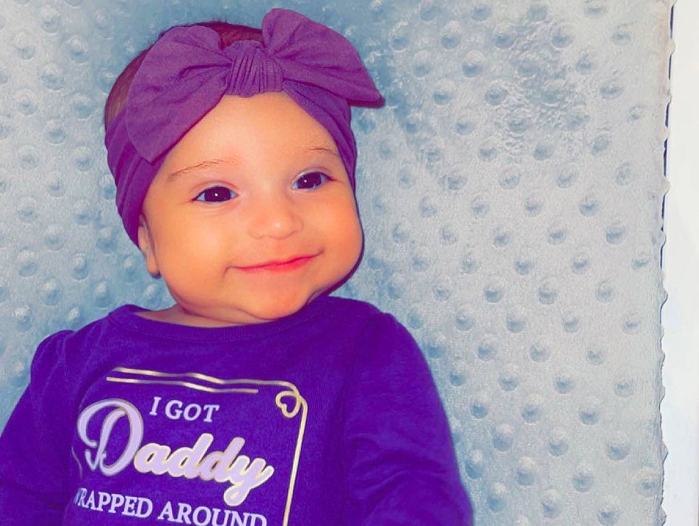 Julia joined the competition — help win amazing prizes! baby, baby_toddler_clothing, beanie, cap, cheek, child, electric_blue, fashion_accessory, happy, headwear, joy, knit_cap, magenta, pattern, person, pink, purple, sleeve, smile, t_shirt