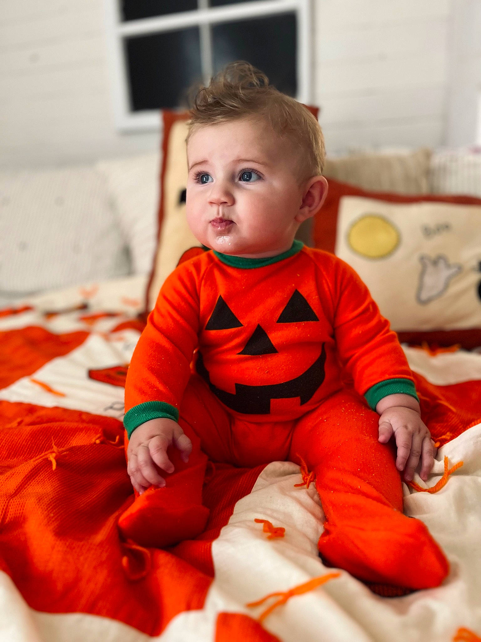Brody is registered to the contest to win money with this photo: baby, baby_toddler_clothing, cheek, child, comfort, eye, face, flooring, fun, happy, head, linens, orange, person, room, sitting, skin, sleeve, t_shirt, toddler