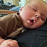 Wylde is registered to the contest to win money with this photo: baby, sleeping, close_up, face, infant, child, cozy, blanket, rest, peaceful, indoors, soft, skin, mouth_open, eyelids_closed, hand, comfort, casual_clothing, nap, relaxation