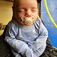 Airis Elaine is registered to the contest to win money with this photo: baby, blue_clothing, child, closeup, cozy, cute, door, floral_pattern, hands, holding, indoor, infant, pacifier, person, portrait, relaxed, sleeping, soft_lighting, window, yellow_stripe