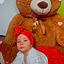 baby, teddy_bear, plush_toy, red_headwrap, red_skirt, white_sweater, cute, indoors, carpet, child, heart_effects, soft_toy, portrait, infant, smiling, crawling, decor, warm_colors, playful, adorable