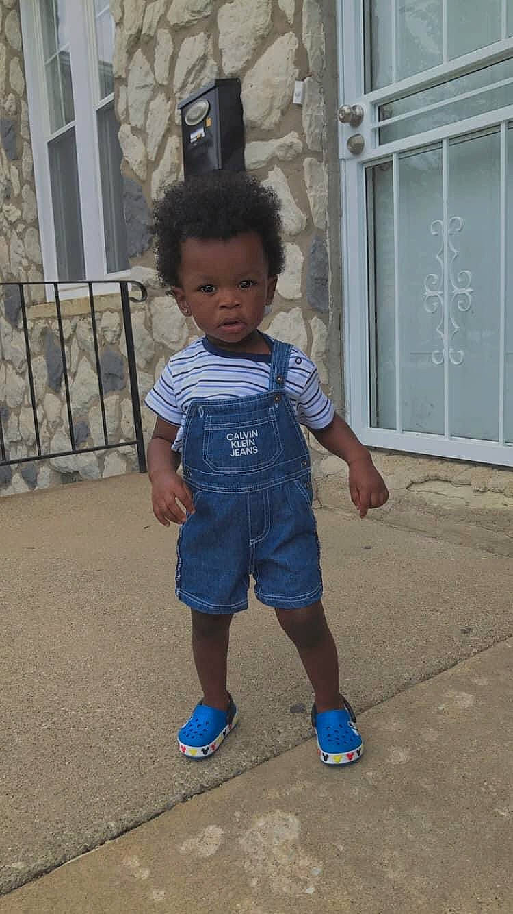 Asiah is registered to the contest to win money with this photo: child, concrete, denim, door, electric_blue, fun, happy, human_body, human_leg, leisure, person, sandal, shoe, shorts, sleeve, sneakers, t_shirt, toddler, waist, walking