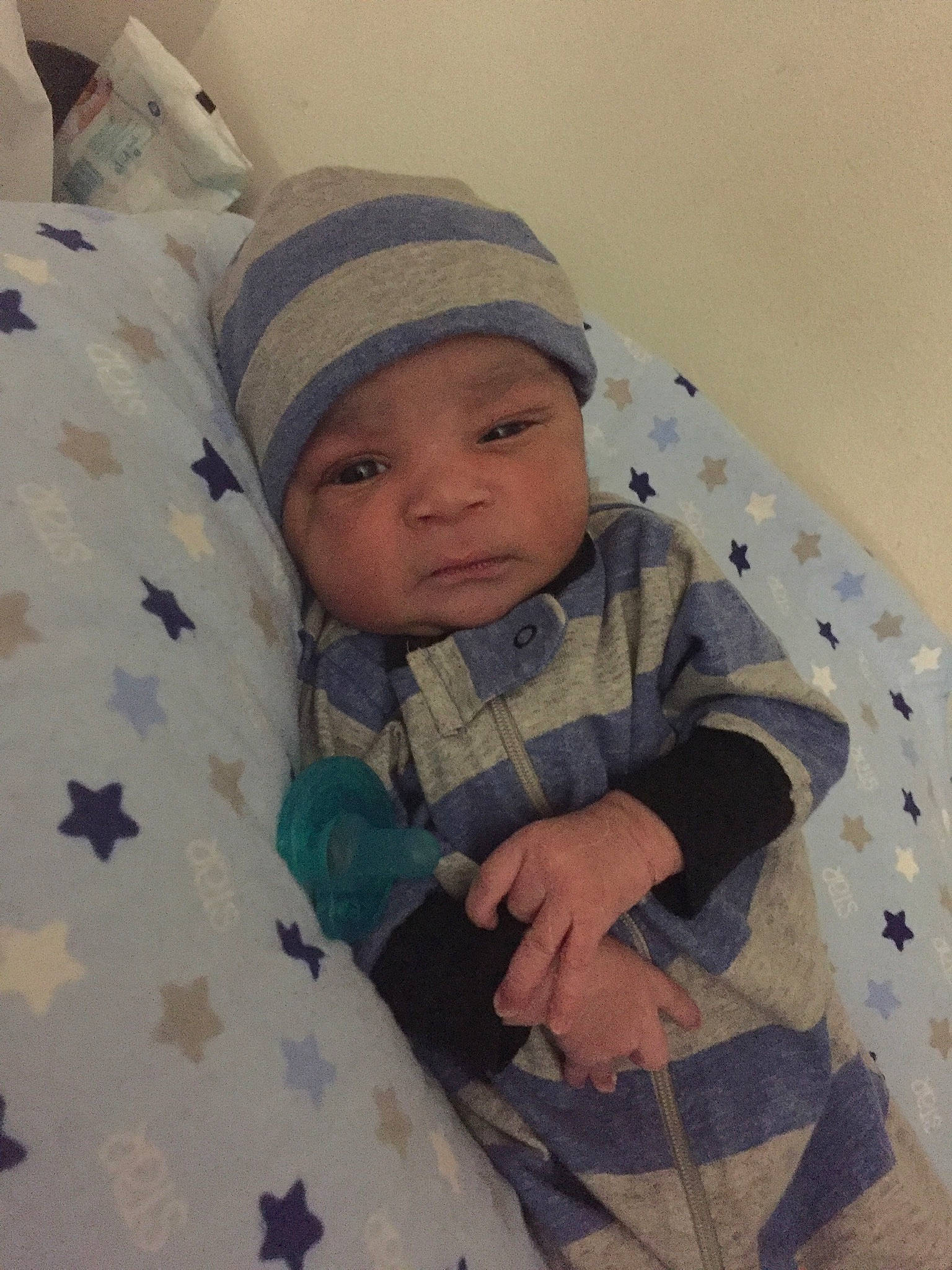 Asiah is registered to the contest to win money with this photo: baby, baby_sleeping, baby_toddler_clothing, beanie, bedding, cap, cheek, child, comfort, eye, headwear, knit_cap, linens, military_camouflage, pattern, person, room, sitting, skin, sleeve